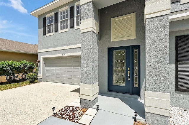9049 Edenshire Cir, Orlando, FL 32836 - entrance to property featuring stucco siding, a garage, and driveway