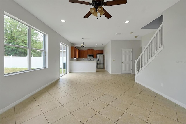9049 Edenshire Cir, Orlando, FL 32836 - unfurnished living room with ceiling fan, light tile patterned floors, recessed lighting, and stairway