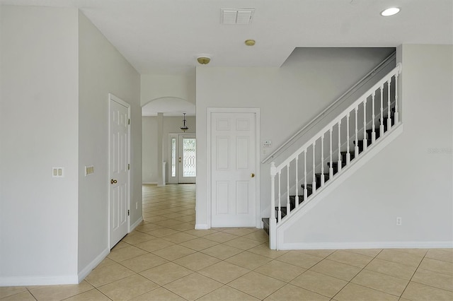9049 Edenshire Cir, Orlando, FL 32836 - staircase featuring tile patterned flooring, arched walkways, and recessed lighting