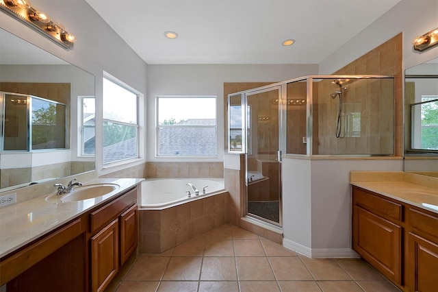 9049 Edenshire Cir, Orlando, FL 32836 - full bathroom with healthy amount of natural light, two vanities, a bath, tile patterned floors, and recessed lighting