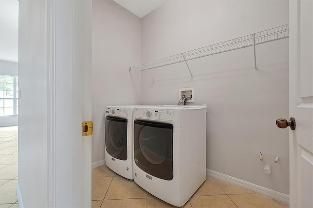 9049 Edenshire Cir, Orlando, FL 32836 - laundry area featuring washing machine and clothes dryer and light tile patterned floors