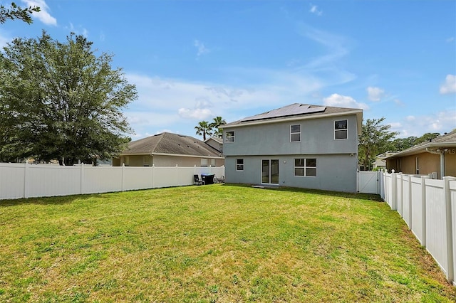 9049 Edenshire Cir, Orlando, FL 32836 - back of house featuring roof mounted solar panels, a fenced backyard, and stucco siding