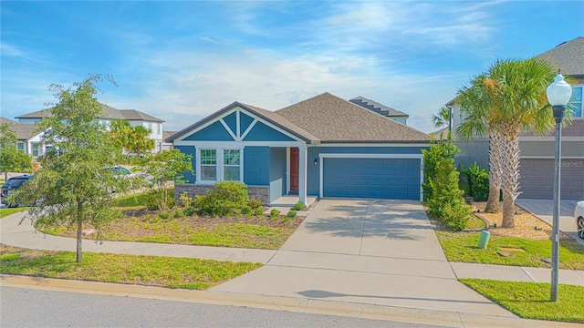 786 Steerview St, Saint Cloud, FL 34771 - view of front of home with a garage, stucco siding, driveway, stone siding, and a shingled roof