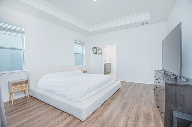 786 Steerview St, Saint Cloud, FL 34771 - bedroom with light wood finished floors, ornamental molding, and a tray ceiling