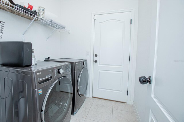 786 Steerview St, Saint Cloud, FL 34771 - washroom with washing machine and dryer and light tile patterned flooring