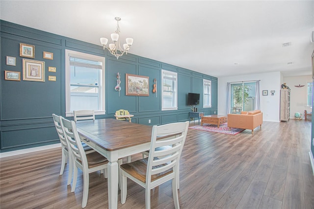786 Steerview St, Saint Cloud, FL 34771 - dining space featuring a decorative wall, a chandelier, and wood finished floors
