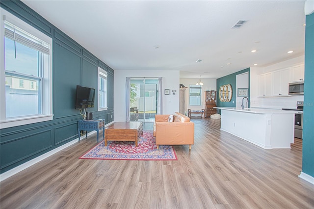 786 Steerview St, Saint Cloud, FL 34771 - living room featuring light wood-type flooring and recessed lighting