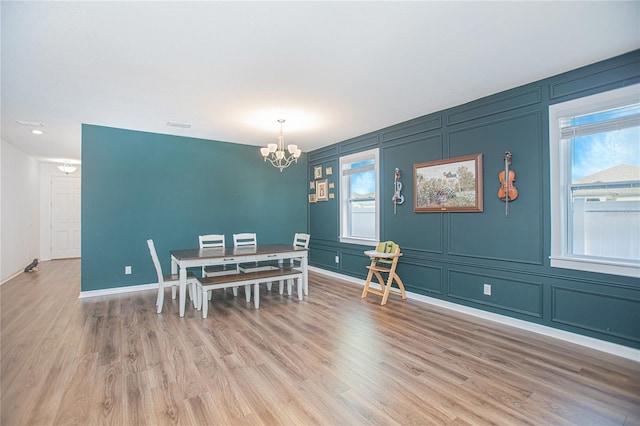 786 Steerview St, Saint Cloud, FL 34771 - dining space with a decorative wall, a chandelier, and light wood-type flooring