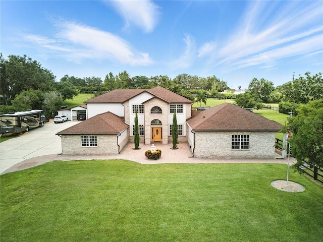 15350 Arabian Way, Montverde, FL 34756 - view of front of house with a front yard, driveway, a shingled roof, and stone siding