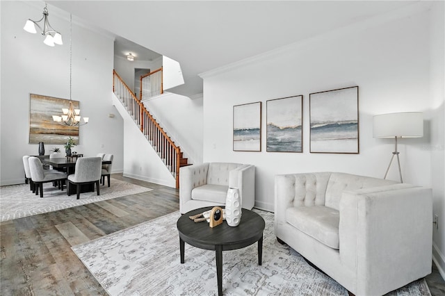15350 Arabian Way, Montverde, FL 34756 - living area with stairway, wood finished floors, crown molding, and a chandelier