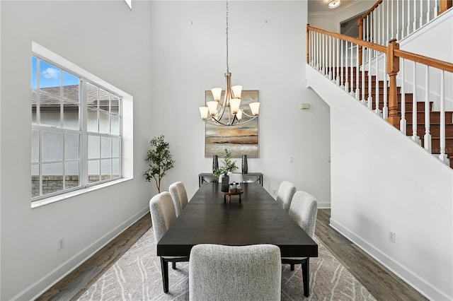 15350 Arabian Way, Montverde, FL 34756 - dining space featuring a towering ceiling, a chandelier, wood finished floors, and stairway