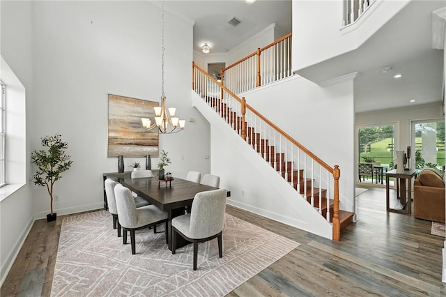 15350 Arabian Way, Montverde, FL 34756 - dining space with a high ceiling, stairs, wood finished floors, a chandelier, and recessed lighting
