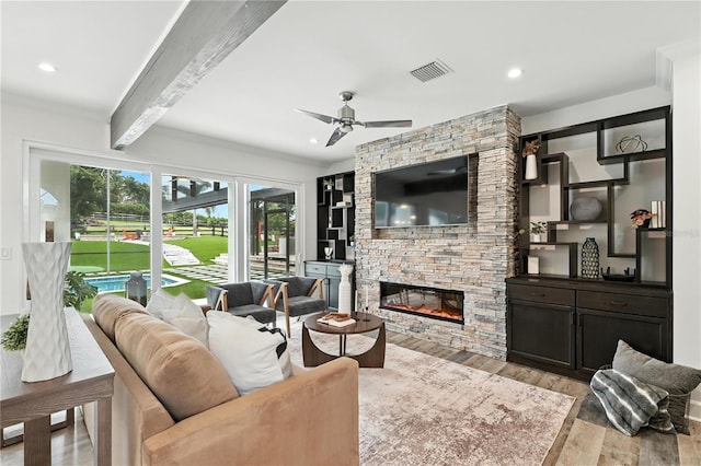 15350 Arabian Way, Montverde, FL 34756 - living area with wood finished floors, beam ceiling, a stone fireplace, ceiling fan, and recessed lighting