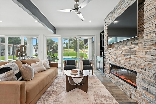 15350 Arabian Way, Montverde, FL 34756 - living area with a ceiling fan, a stone fireplace, healthy amount of natural light, beamed ceiling, and ornamental molding