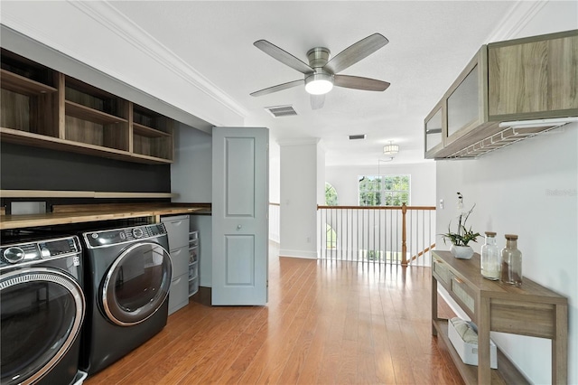 15350 Arabian Way, Montverde, FL 34756 - washroom featuring washing machine and clothes dryer, a ceiling fan, light wood finished floors, and ornamental molding