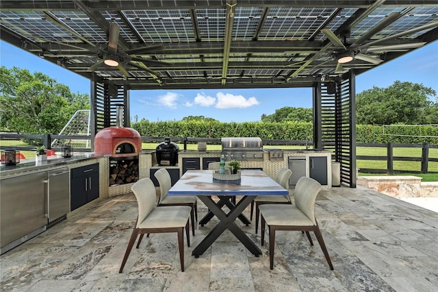 15350 Arabian Way, Montverde, FL 34756 - view of patio / terrace with exterior kitchen, ceiling fan, and outdoor dining space