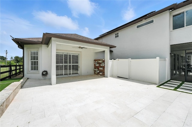 15350 Arabian Way, Montverde, FL 34756 - back of property featuring a patio, a ceiling fan, stucco siding, and a shingled roof