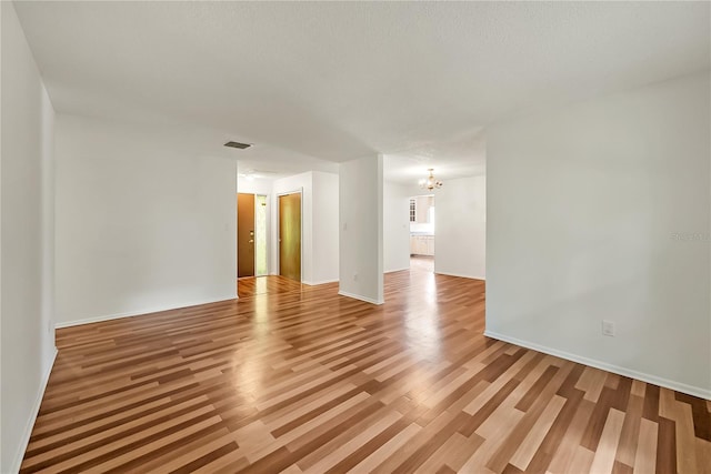 877 Great Bend Rd, Altamonte Springs, FL 32714 - empty room with a chandelier and light wood finished floors