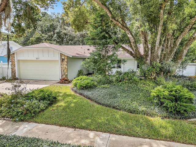 877 Great Bend Rd, Altamonte Springs, FL 32714 - view of front of property with stone siding, a garage, concrete driveway, roof with shingles, and board and batten siding