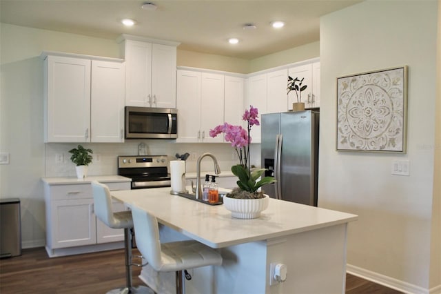 4426 Small Creek Rd, Kissimmee, FL 34744 - kitchen with appliances with stainless steel finishes, light countertops, white cabinets, dark wood-style flooring, and recessed lighting