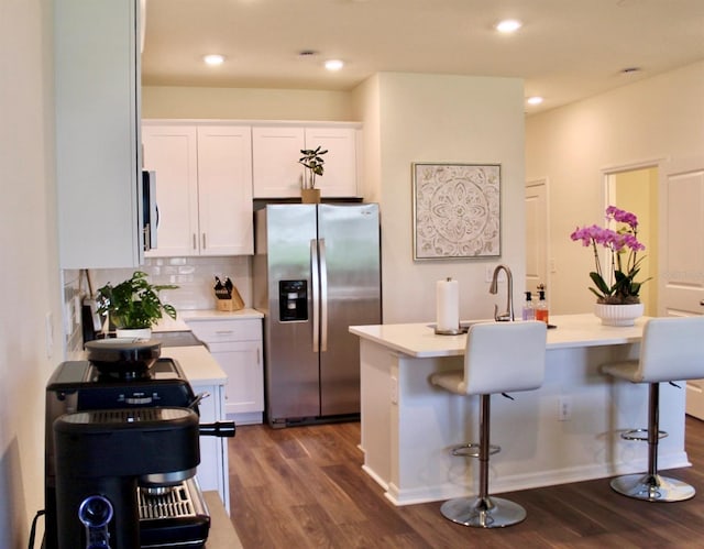 4426 Small Creek Rd, Kissimmee, FL 34744 - kitchen featuring stainless steel appliances, dark wood finished floors, light countertops, white cabinets, and recessed lighting