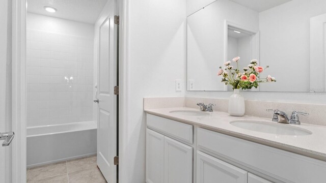 7898 Poplin St, Kissimmee, FL 34747 - full bathroom with double vanity, tile patterned flooring, and  shower combination