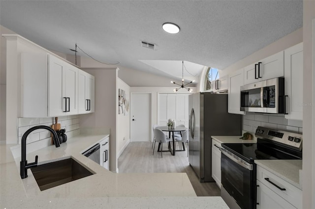 2898 Picadilly Cir, Kissimmee, FL 34747 - kitchen with stainless steel appliances, decorative backsplash, light stone countertops, a chandelier, and a textured ceiling