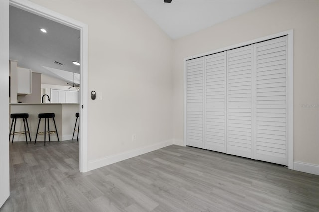 2898 Picadilly Cir, Kissimmee, FL 34747 - unfurnished bedroom with lofted ceiling, wood finished floors, a closet, and recessed lighting