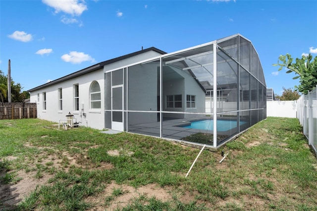 2898 Picadilly Cir, Kissimmee, FL 34747 - back of house with a fenced backyard, stucco siding, a patio area, and a lanai