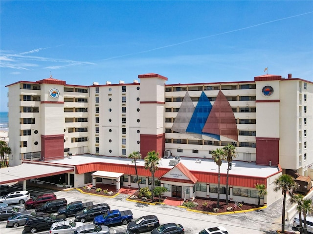701 S Atlantic Ave Unit 504, Daytona Beach, FL 32118 - view of apartment building / complex featuring uncovered parking
