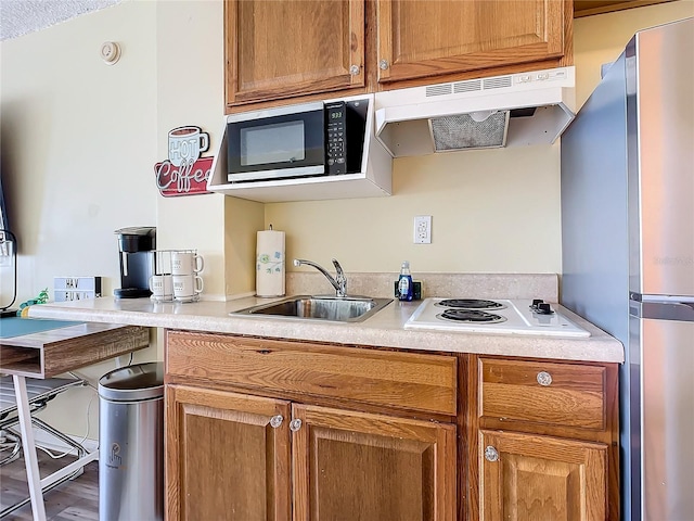 701 S Atlantic Ave Unit 504, Daytona Beach, FL 32118 - kitchen featuring appliances with stainless steel finishes, under cabinet range hood, and light countertops