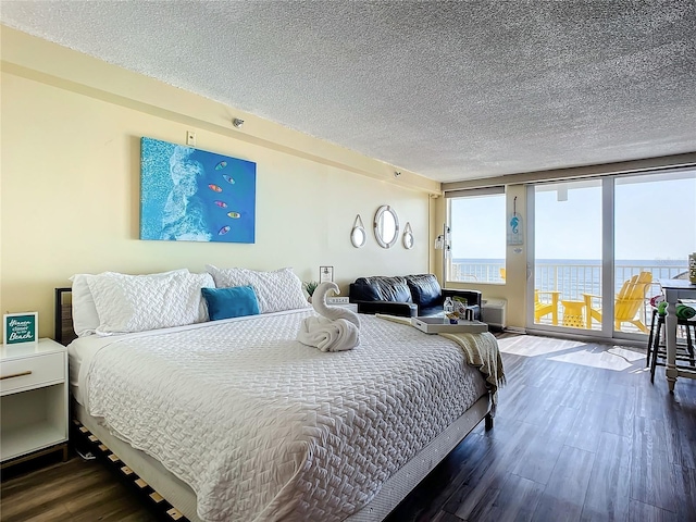 701 S Atlantic Ave Unit 504, Daytona Beach, FL 32118 - bedroom with dark wood-style floors, a textured ceiling, and access to exterior