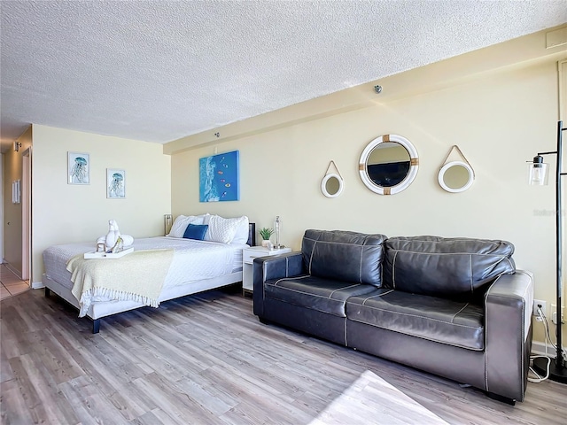 701 S Atlantic Ave Unit 504, Daytona Beach, FL 32118 - bedroom featuring wood finished floors and a textured ceiling