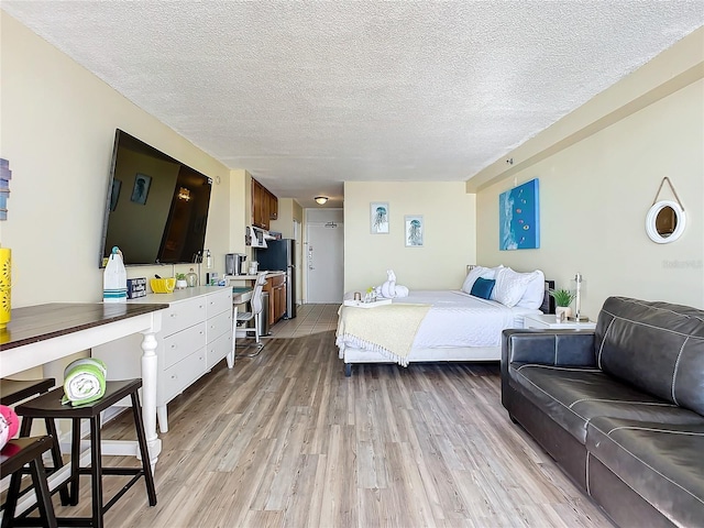 701 S Atlantic Ave Unit 504, Daytona Beach, FL 32118 - bedroom with light wood-type flooring and a textured ceiling