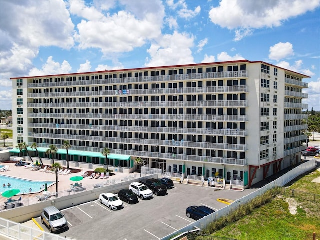 701 S Atlantic Ave Unit 504, Daytona Beach, FL 32118 - view of apartment building / complex featuring uncovered parking and a community pool