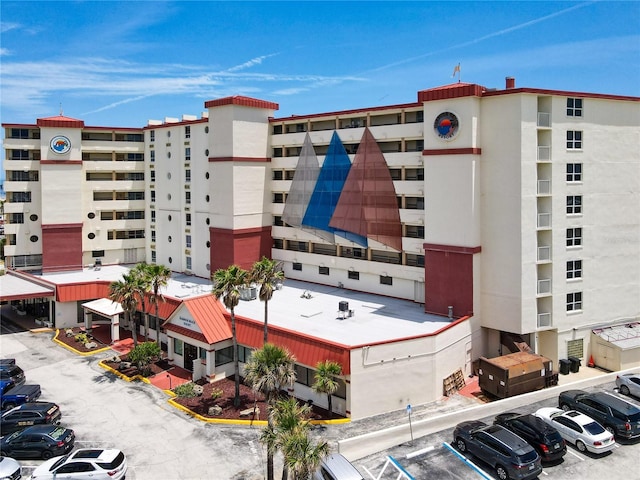 701 S Atlantic Ave Unit 504, Daytona Beach, FL 32118 - view of apartment building / complex featuring uncovered parking