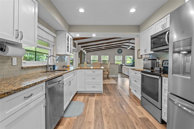 11815 Lake Susan, Clermont, FL 34711 - kitchen with stainless steel appliances, a peninsula, white cabinetry, decorative backsplash, and recessed lighting