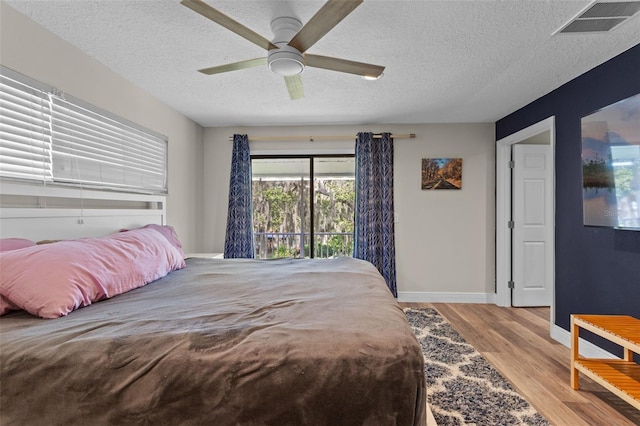 11815 Lake Susan, Clermont, FL 34711 - bedroom with a textured ceiling, wood finished floors, and a ceiling fan