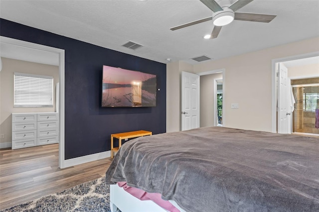 11815 Lake Susan, Clermont, FL 34711 - bedroom with wood finished floors, ceiling fan, and ensuite bath