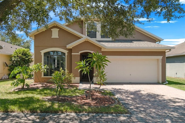 523 Lake Davenport Cir, Davenport, FL 33837 - view of front of property featuring stucco siding, a garage, and decorative driveway