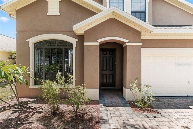523 Lake Davenport Cir, Davenport, FL 33837 - view of exterior entry with stucco siding and decorative driveway