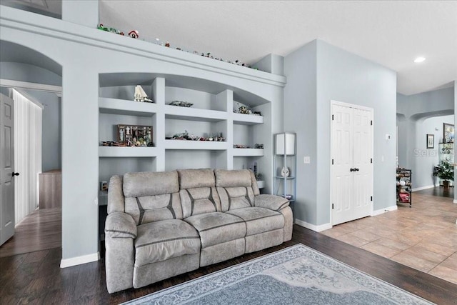 523 Lake Davenport Cir, Davenport, FL 33837 - living room with wood finished floors, built in shelves, recessed lighting, and arched walkways