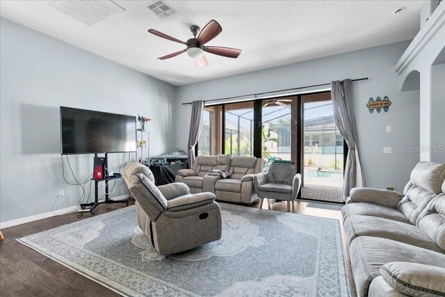 523 Lake Davenport Cir, Davenport, FL 33837 - living room featuring arched walkways, a ceiling fan, and wood finished floors