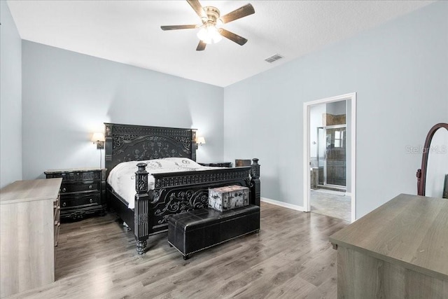 523 Lake Davenport Cir, Davenport, FL 33837 - bedroom with wood finished floors, ensuite bathroom, and a ceiling fan