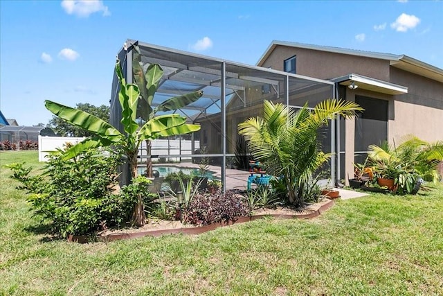 523 Lake Davenport Cir, Davenport, FL 33837 - back of property featuring stucco siding, an outdoor pool, a yard, and glass enclosure
