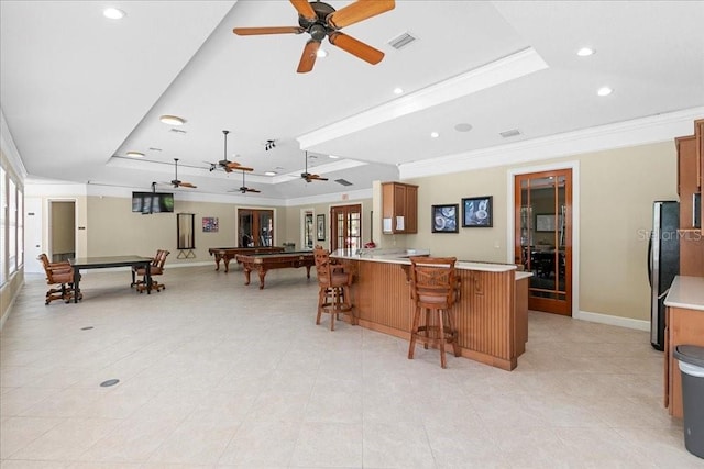 523 Lake Davenport Cir, Davenport, FL 33837 - kitchen featuring a tray ceiling, ceiling fan, ornamental molding, billiards table, and freestanding refrigerator