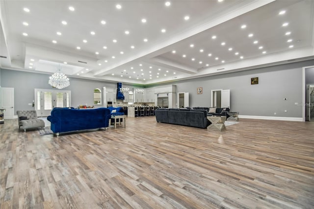 15715 Trousdale St, Clermont, FL 34715 - living area featuring a raised ceiling, light wood-style floors, a chandelier, french doors, and recessed lighting