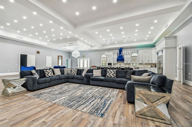 15715 Trousdale St, Clermont, FL 34715 - living room with a chandelier, light wood-style flooring, recessed lighting, ornamental molding, and a tray ceiling