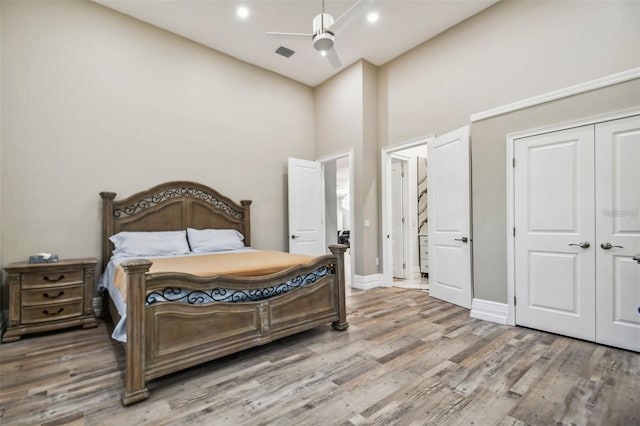 15715 Trousdale St, Clermont, FL 34715 - bedroom with wood finished floors, a closet, ceiling fan, and a towering ceiling