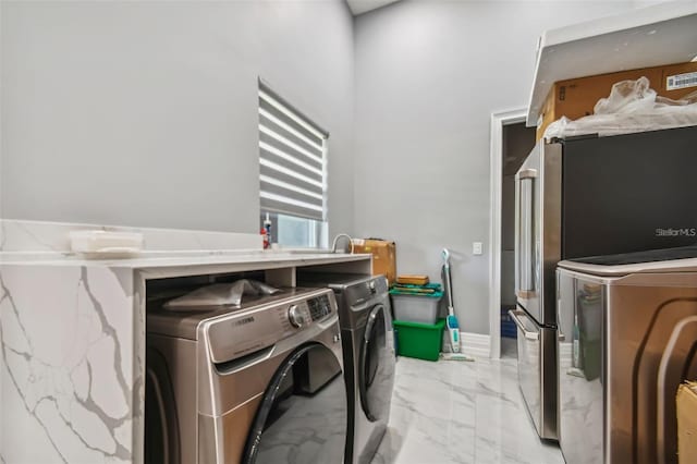 15715 Trousdale St, Clermont, FL 34715 - laundry room featuring independent washer and dryer and light marble finish floors